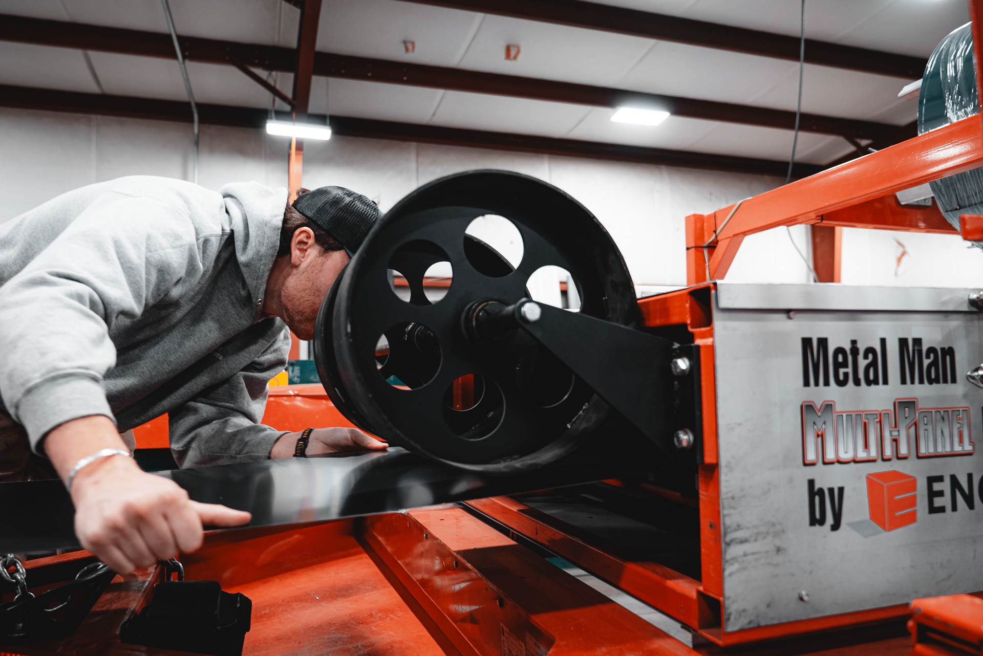 Rollforming a charcoal R-panel on the Metal Roof Components shop floor